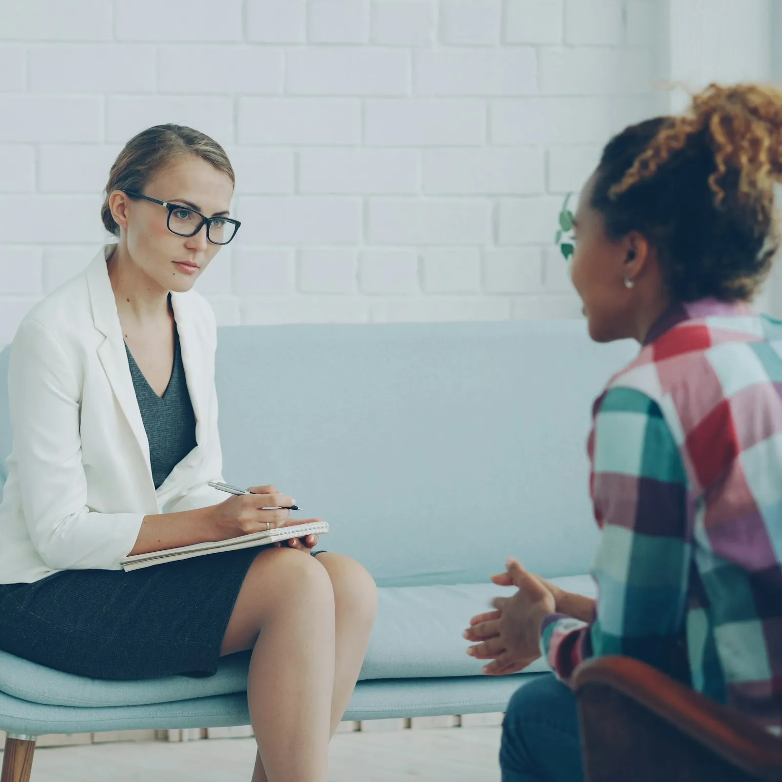 A therapist listening to a client across a table