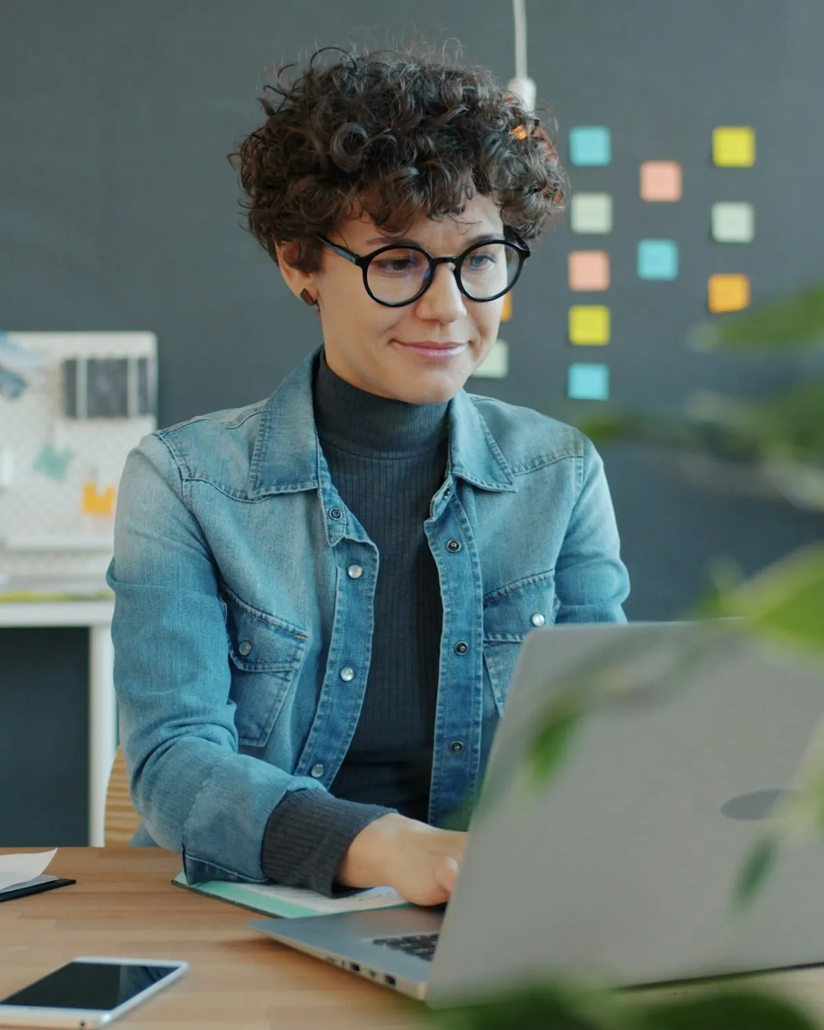 A consultant working at a laptop in a bright office