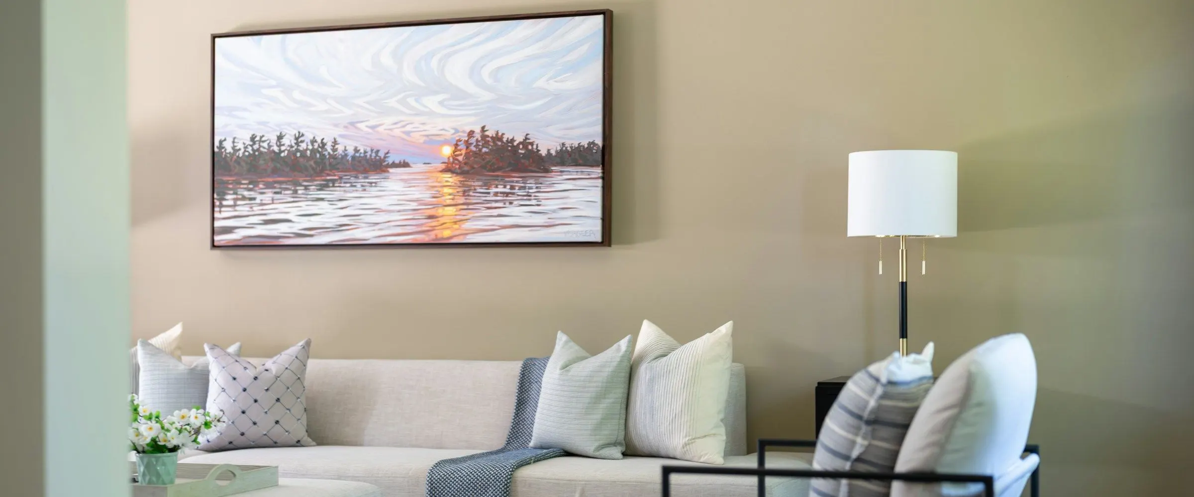 A landscape print over the sofa
