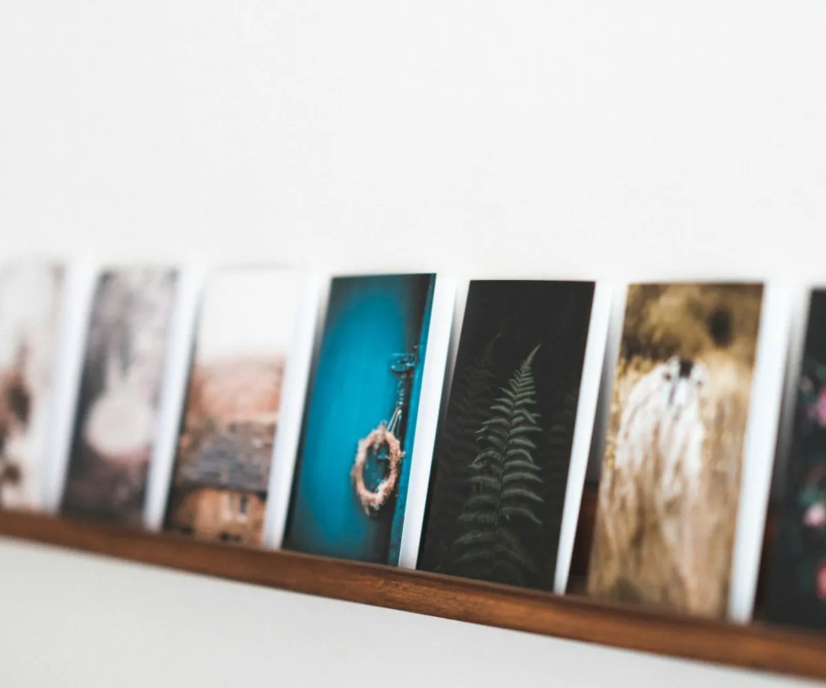 Postcard prints along a picture ledge