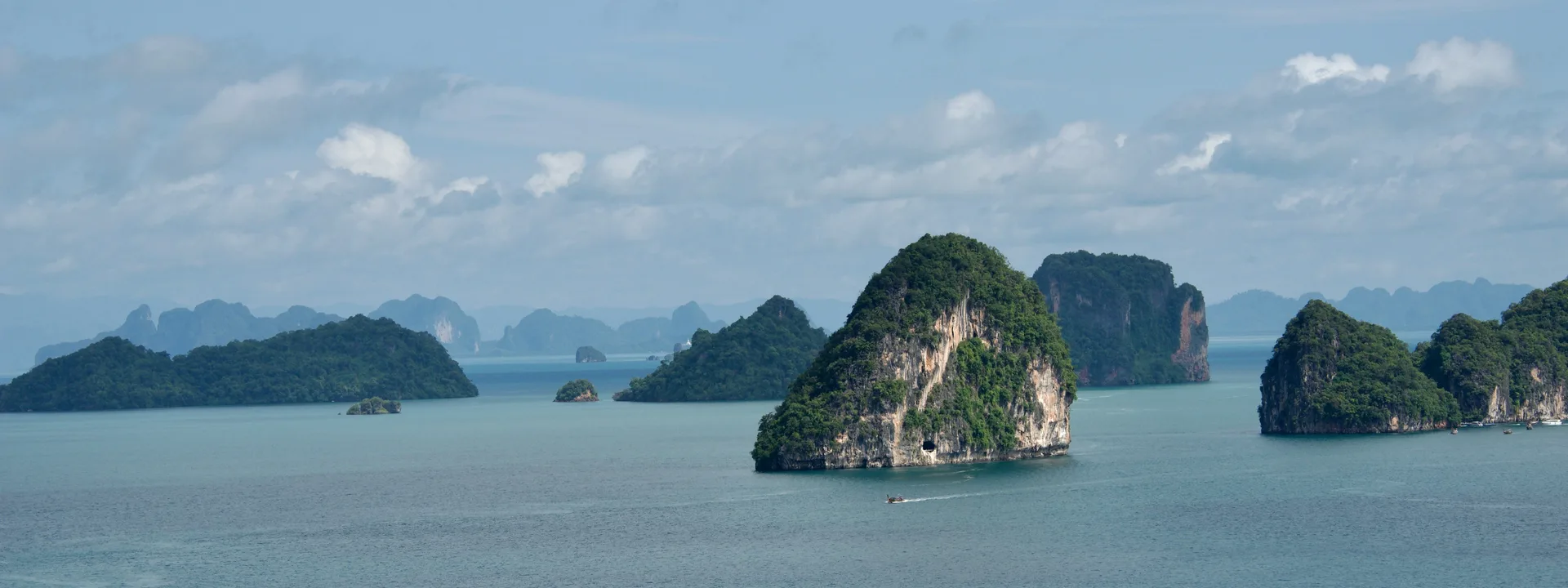 Green karst islands scattered across a calm bay