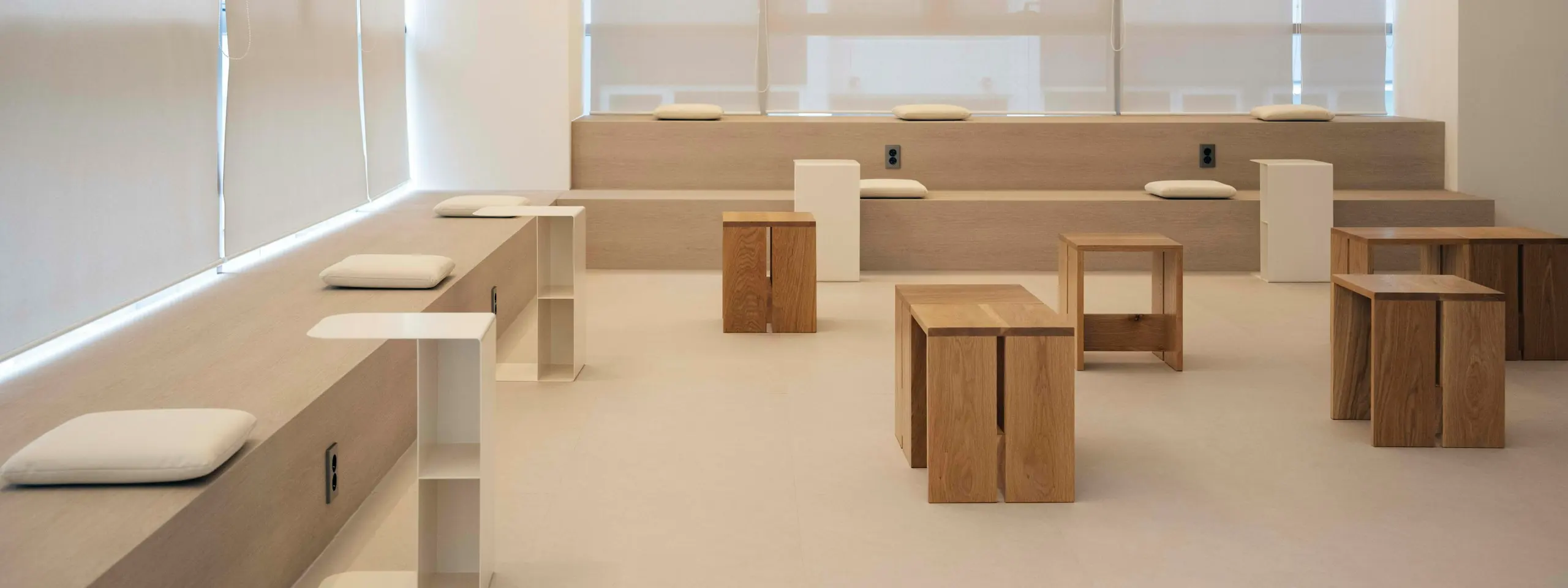 Our bright studio lounge with wooden benches and stools