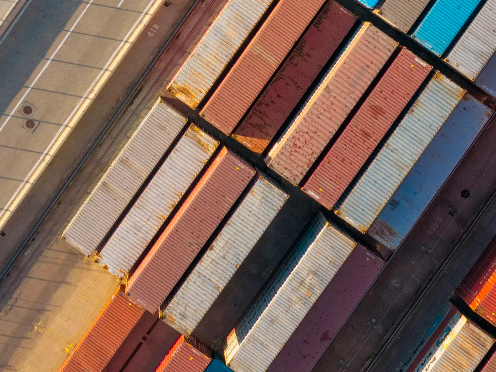 Shipping containers in rows at a port, seen from above