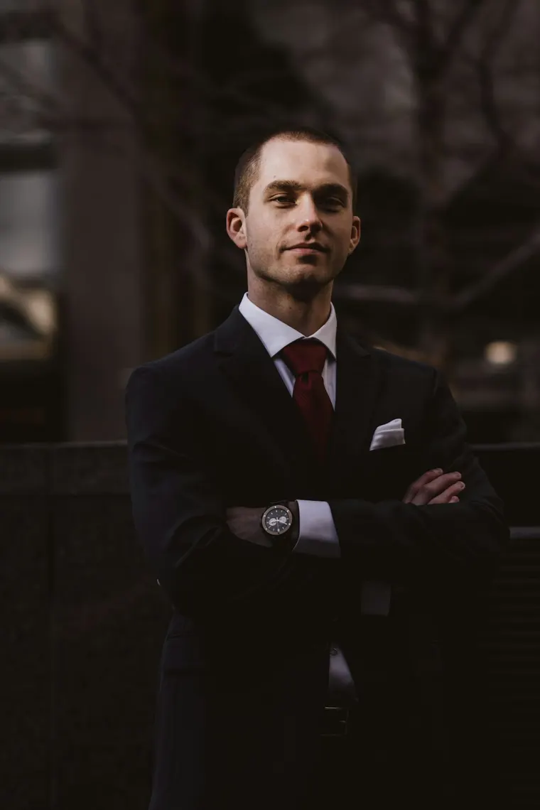 Lawyer in a dark suit, arms crossed