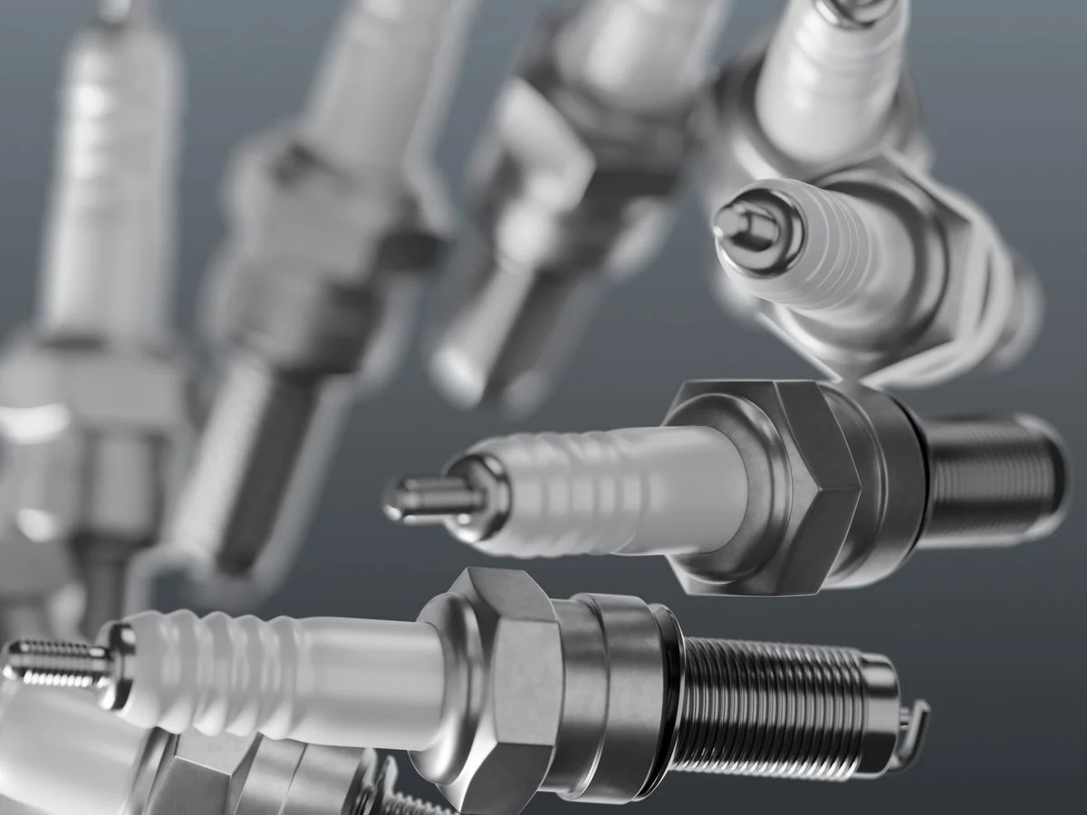 Spark plugs on a grey backdrop