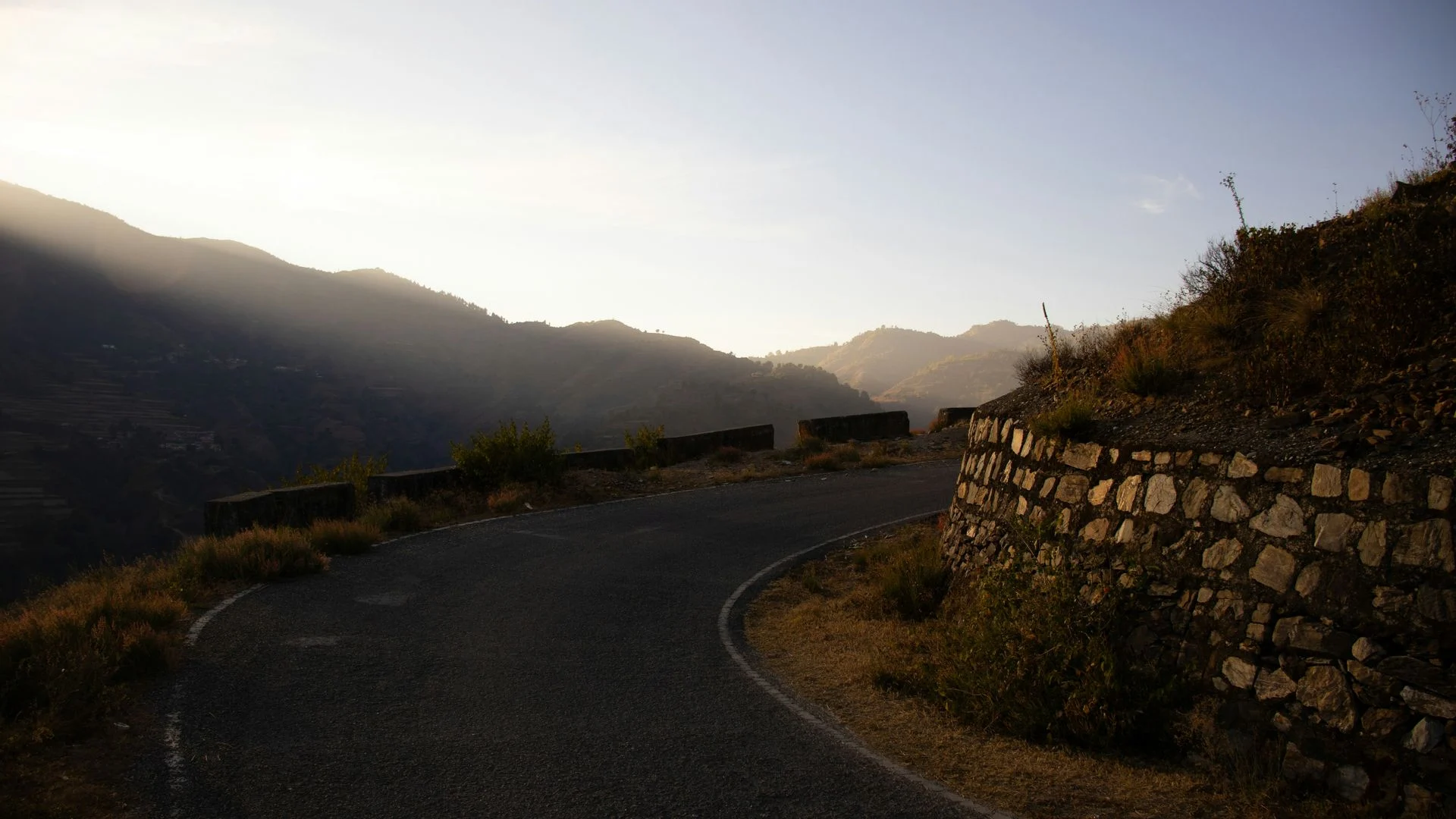 An empty mountain road at dusk